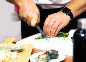 Obraz na płótnie Canvas Chef cooking, Chef preparing food in the kitchen