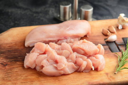 Raw chicken meat on wooden board