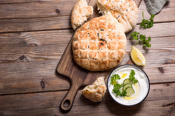 Flatbread, baked traditional oriental or indian bread with yoghurt dip