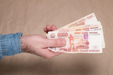 Male hand with russian money studio image. Man's hand holds Russian rubles. Male hand with money.