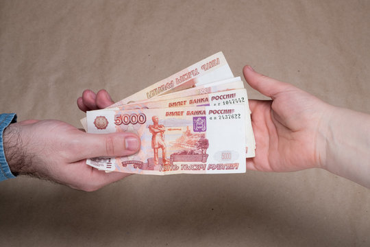 Male hand with russian money studio image. Man's hand holds Russian rubles. Male hand with money.