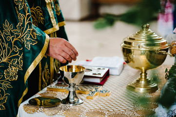The priest blesses cup. the Bible, cross on table. Priest during a wedding ceremony. Priest celebrate a mass at the church. traditional wedding ceremony.