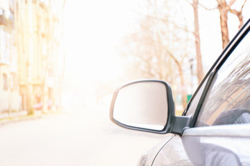 Side mirror of modern car on city street