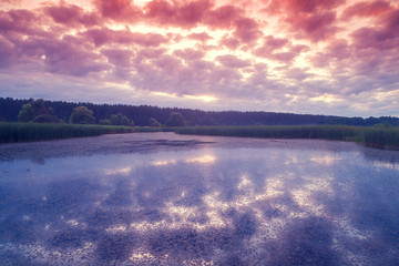 Cloudy sunset sky over the lake. Aerial view