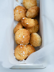 Delicious just baked homemade coconut biscuits with baking paper as a backgroung.