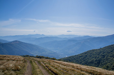 Fototapeta premium Colorful mountain landscape in the summer mountains. Large hills with blue sky.
