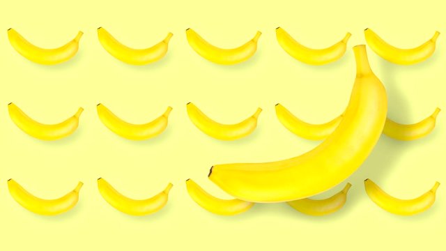 Animated movie with moving and rotating fruits. Photograph of a banana whole and counter-moving in yellow uniform tone.