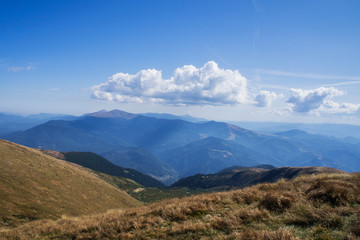 Colorful mountain landscape in the summer mountains. Large hills with blue sky.