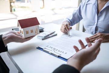 Real estate agent are presenting home loan and sending keys to customer after signing contract to buy house with approved property application form, Insurance Home concept