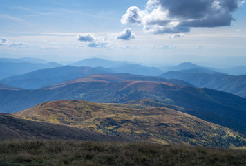 Obraz premium Colorful mountain landscape in the summer mountains. Large hills with blue sky.