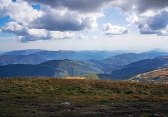Colorful mountain landscape in the summer mountains. Large hills with blue sky.