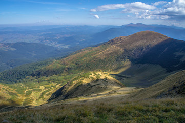 Naklejka premium Colorful mountain landscape in the summer mountains. Large hills with blue sky.