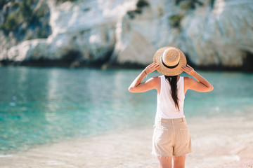 Fototapeta premium Woman laying on the beach enjoying summer holidays looking at the sea