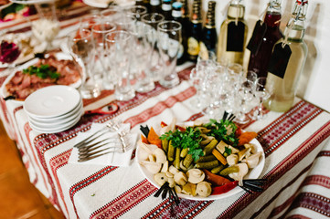 The holiday table cheese, meat. Served table with food. Festive table. Wedding table, food, drinks, water. Table at restaurant before starting to celebrate.