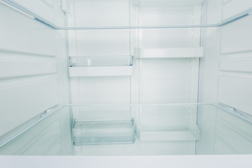 Clean empty shelves in white refrigerator