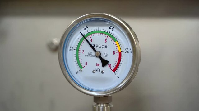 Pressure Gauge or Manometer with chinese hieroglyphs on China factory, close up