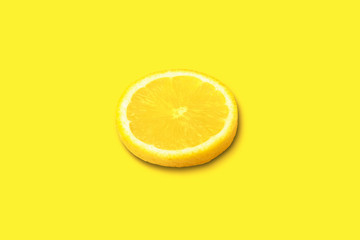 ripe lemon slice on yellow background, citrus fruit on bright