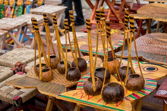 Indian traditional handmade monochords isolated on blurred background are displayed in a street shop for sale. Indian handicraft and art