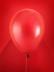 Red balloon on red background