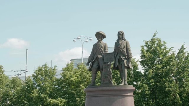 Monument to founders of ekateriburg. Piece of history. green trees and blue sky on background.