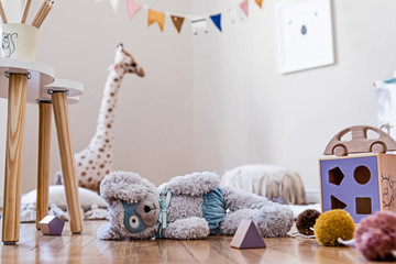 Stylish scandinavian interior of child room with natural toys, hanging decoration, design...