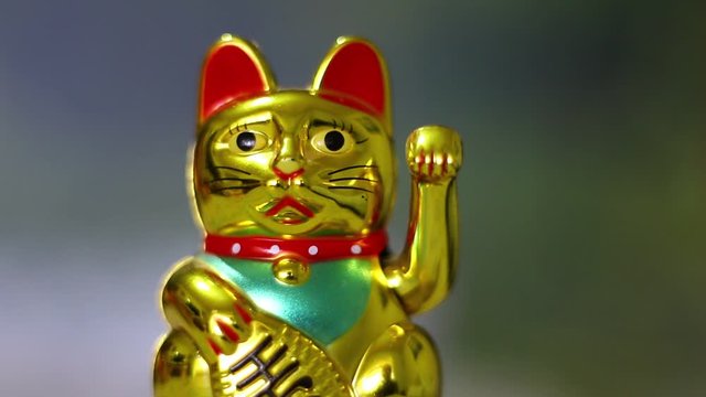 Maneki-neko - Chinese cat of luck with a waving paw