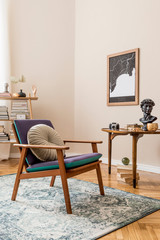 Interior design of stylish library room with retro armchair, wooden table, bookstand, books, mock up poster map, vintage carpet and elegant personal accessories. Beige wall. Home decor. Template.