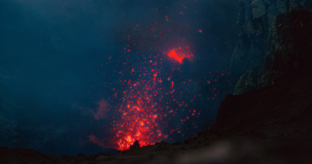 CLOSE UP: Glowing hot magma bursting out of the volcanic crater in Vanuatu.