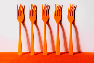 Orange forks in a row