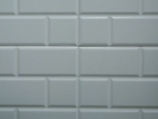 White brick wall with a liner between each