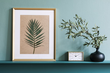 Stylish living room interior at elegant apartment with mock up poster frame, flowers in vase, gold...