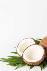 Ripe half cut coconut on a wooden background. Coconut cream and oil.
