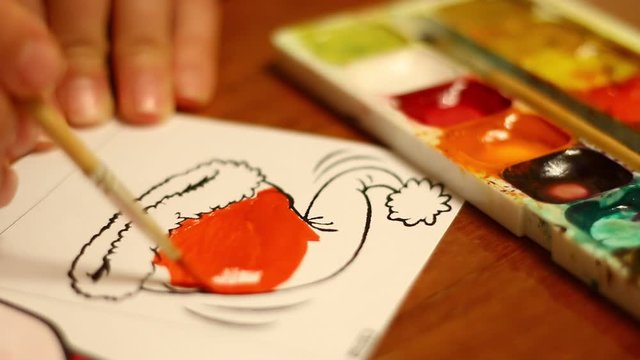 Coloring of Santa Claus hats with watercolor paints