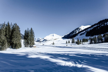 winter in mountains with lots of snow, bright blue sky