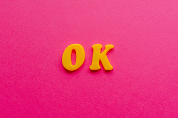 ok from plastic magnets on paper background