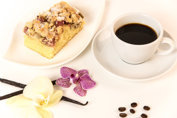 on a white background stands a cup of coffee and a plate with cake and orchids as decoration