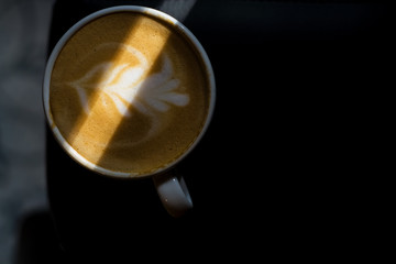 White ceramic a cup of cappuccino with picture, latte art in coffee shop. The morning drink. Fresh coffee.