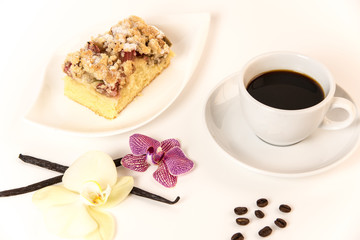 on a white background stands a cup of coffee and a plate with cake and orchids as decoration