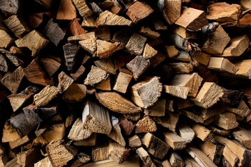 A lot of pine firewood stacked in one place