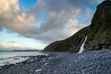Waterfall on Bucks Mill pebble beach in North Devon