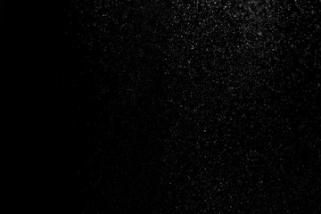 white powder on black background, in defocus. Background abstract.