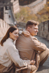 beautiful young couple showing affection on the Great Wall of China. Newly married couple on their honemoon to Great Wall near Beijing China. Stylish couple exploring one of the wonders of the world