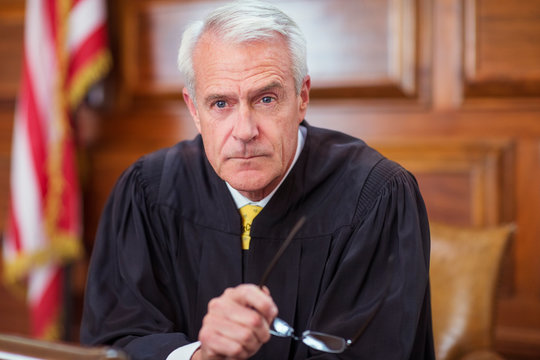 Judge Sitting Behind Judges Bench In Court