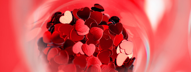 Red hearts are scattered in a glass. Valentine's Day concept.