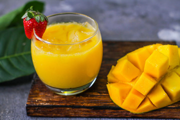 Photo of mango juice with mango slice. Fresh mango juice in the glass. Healthy breakfast. High vitamin C fruit. Green Fruit. Image