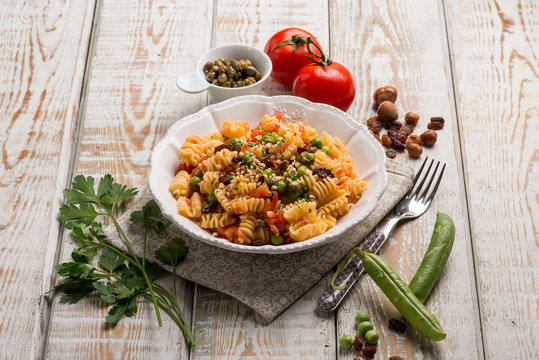 pasta with fresh tomatoes green peas capers and hazelnuts