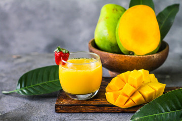 Photo of mango juice with mango slice. Fresh mango juice in the glass. Healthy breakfast. High vitamin C fruit. Green Fruit. Image