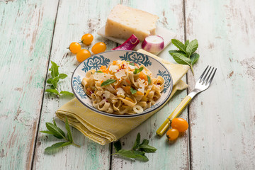 tagliatelle pasta with yellow fresh tomatoes sheep cheese and mint leaves