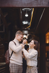 newlywed couple eating noodles with chopsticks in Shanghai outside a food market near Yuyuan. Couple eating authentic local food. husband and wife eating chinese food outisde of a food hall