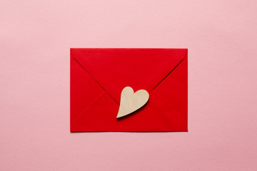Wooden beautiful hearts on a red paper envelope love message for Valentine's Day and Women's Day